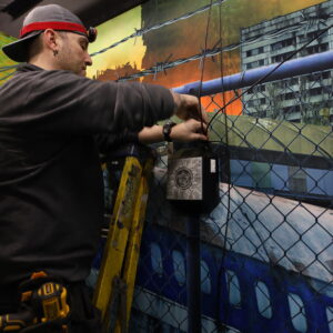 Man installing a laser tag element in a laser tag arena.