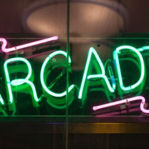 Green and pink lit up Arcade neon light sign.