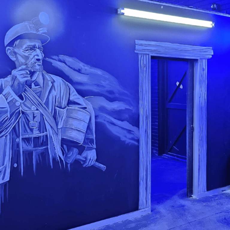 Historic miner painted on the wall of the Gold Reef Theme Park laser tag arena.