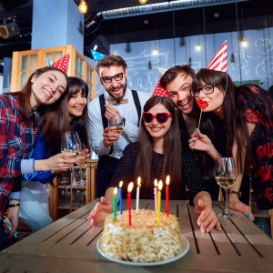 Group of young adults having a birthday party.