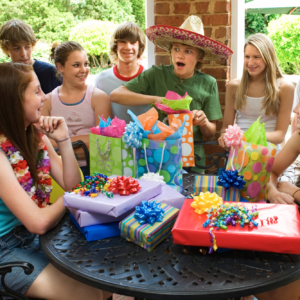 Group of teenagers having a group birthday party.