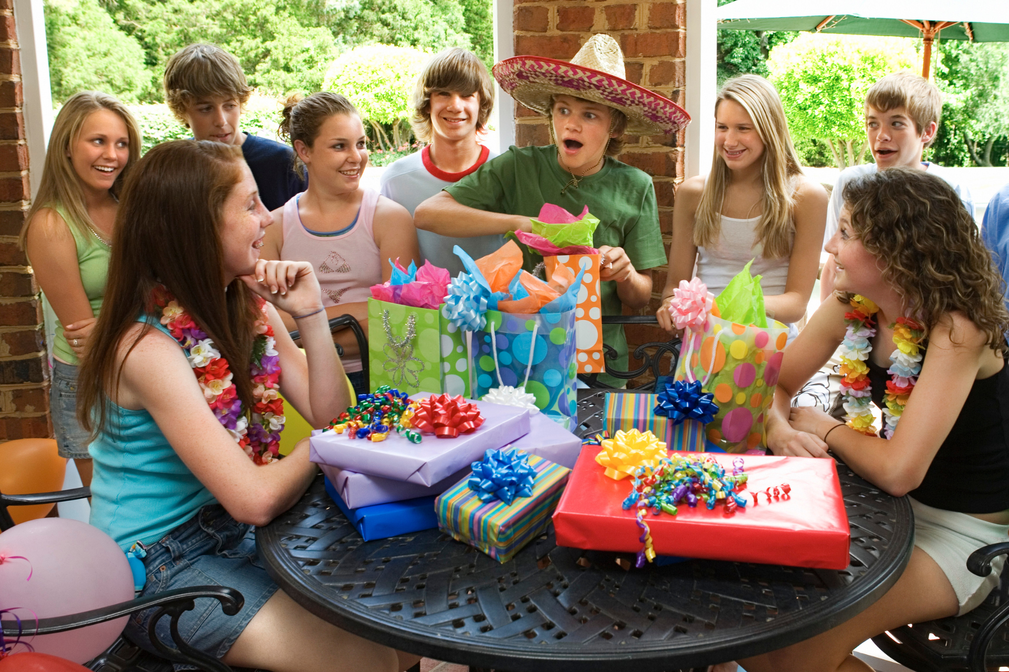 Group of teenagers having a group birthday party.