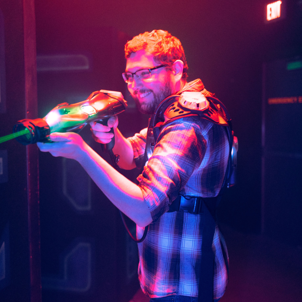 Male wearing a CyberBlast Pro laser tag vest and firinghis phaser.