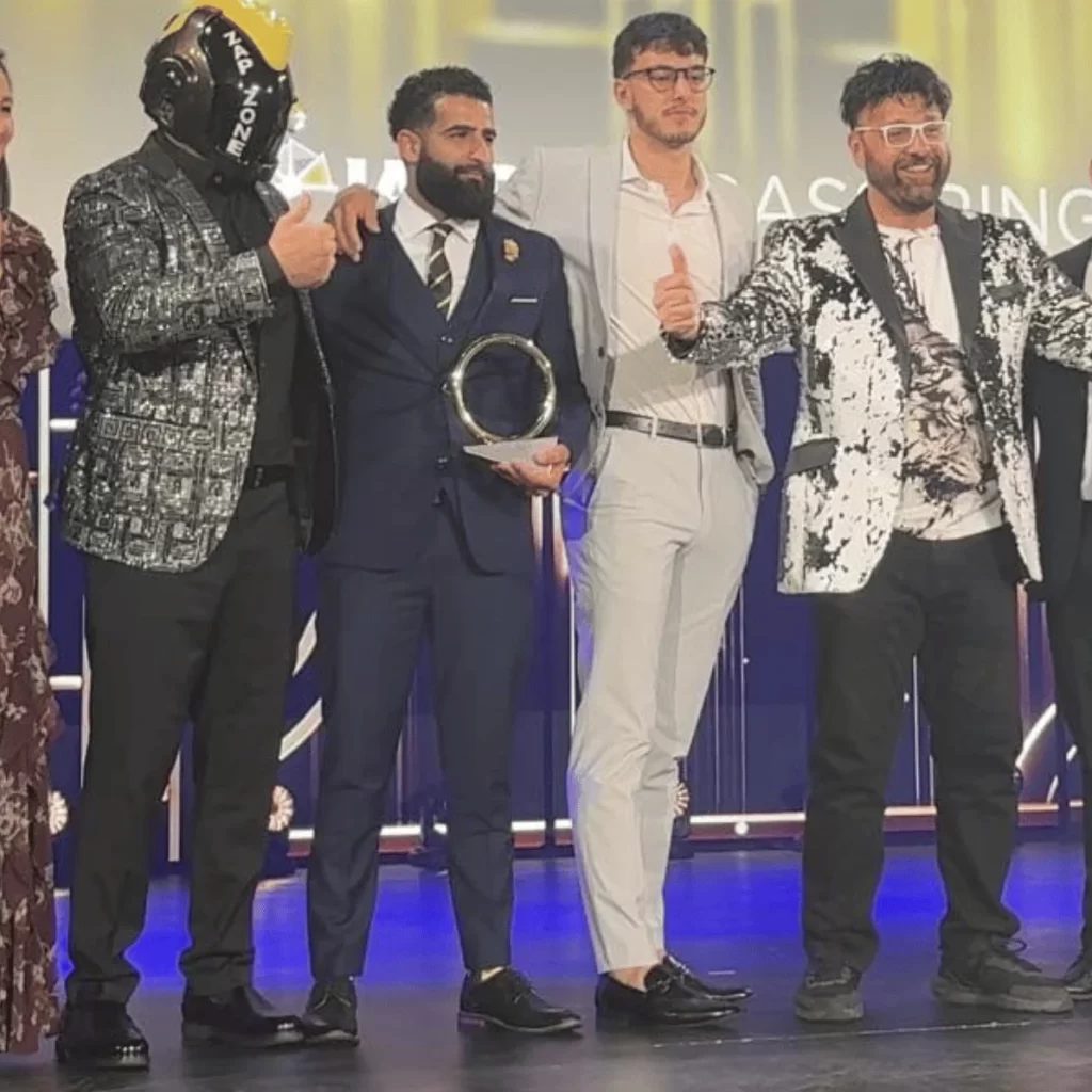 A line of men and woman on a stage in dress attire at the IAAPA Honors award ceremony.